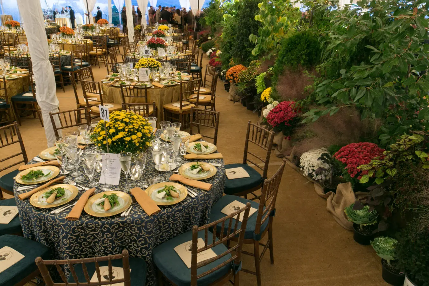 Circular tables and greenery set up for a tented event at George Washington's Mount Vernon.